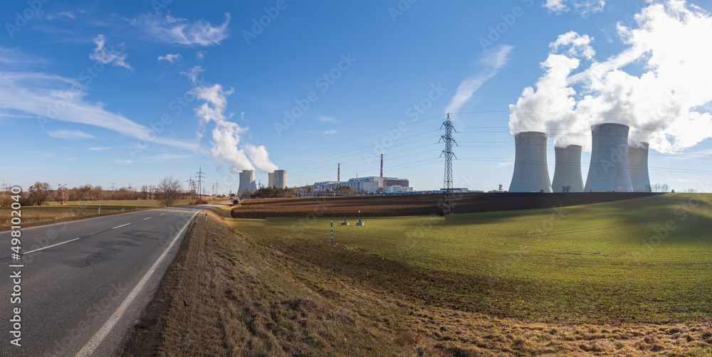Dukovany Nuclear Power Plant in the Czech Republic, Europe. Smoke cooling towers. There are clouds in the sky. In the background the nature of the Highlands.