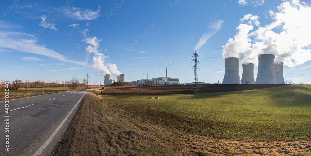 Dukovany Nuclear Power Plant in the Czech Republic, Europe. Smoke cooling towers. There are clouds in the sky. In the background the nature of the Highlands. Dukovany Nuclear Power Plant in the Czech Republic, Europe. Smoke cooling towers. There are clouds in the sky. In the background the nature of the Highlands.