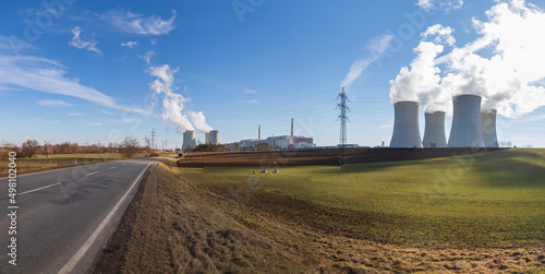 Dukovany Nuclear Power Plant in the Czech Republic, Europe. Smoke cooling towers. There are clouds in the sky. In the background the nature of the Highlands. photo
