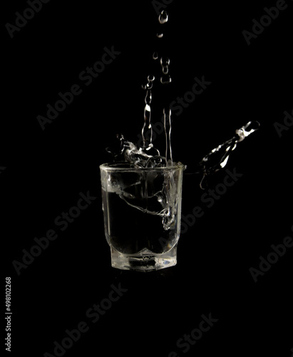 Glass with water drops on a black background