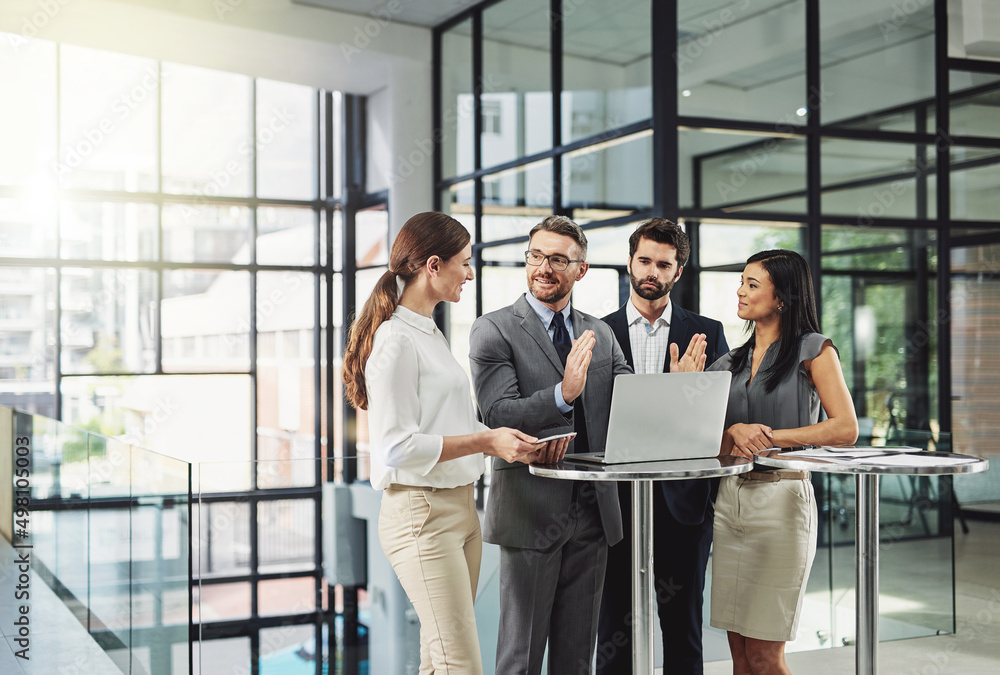 © Ruan Jordaan/peopleimages.com - Teamwork is the quickest way to success. Shot of a group of colleagues discussing business in the office.