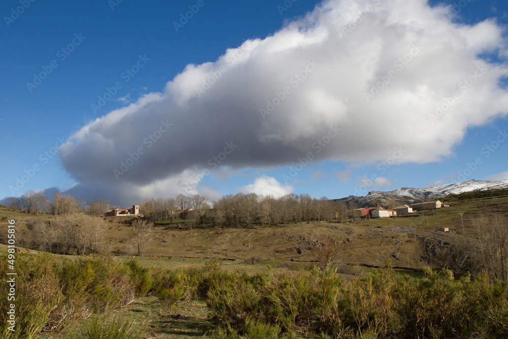 Mountain town of La Lastra with a big cloud in the sky , Palencia, Spain 