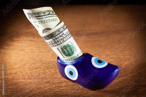 Dollar bill sticking out of toy shoes
