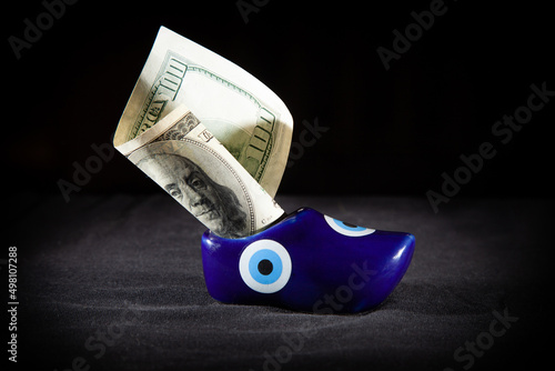 Dollar bill sticking out shoe