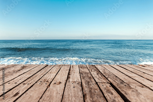 Old boards  floor against the background of the blue sea and sky. The concept of vacation  travel  vacation  wallpaper.