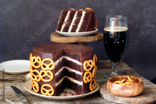 Beer chocolate cake. Pretzels. Guinness. Side view. wooden background.