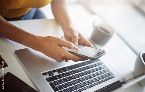 My clients can get hold of me anytime, anyplace. Closeup shot of an unrecognizable female designer using a cellphone in her home office.