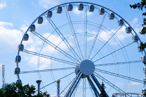 Ferris wheel in an amusement park.Against the blue sky.