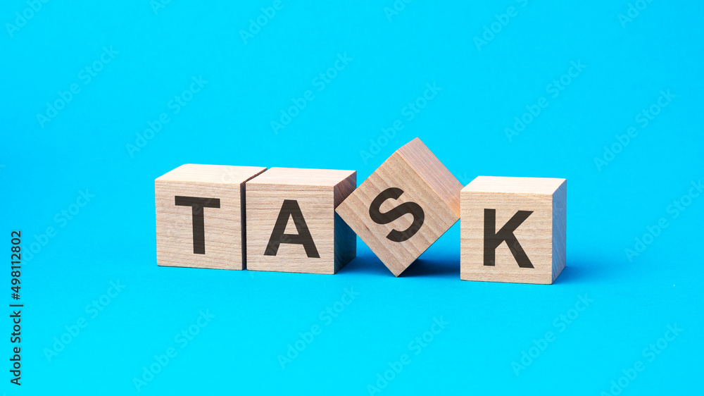task - text on wooden blocks, business concept, blue background task - text on wooden blocks, business concept, blue background