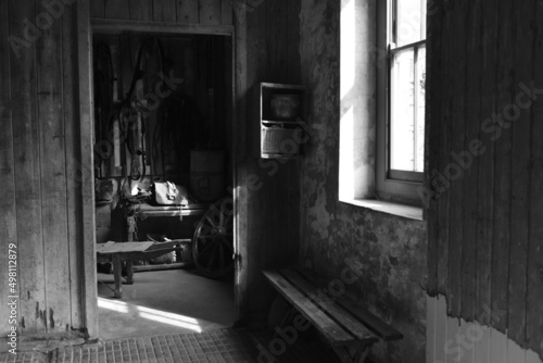 The riding tack room, Jersey, U.K. Black and white image of a working stable from a bygone era.