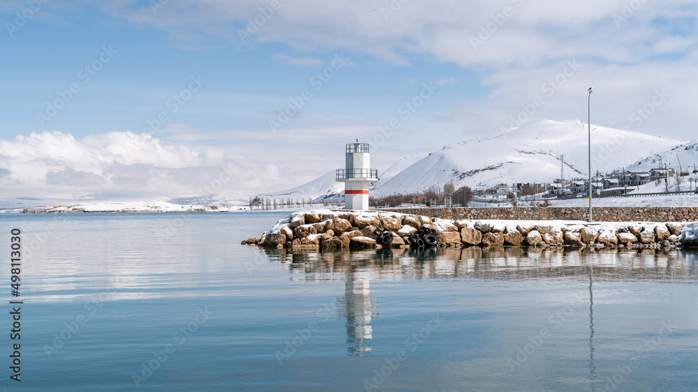 Small lighthouse at Lake of Van with snow and winter landscape, Van, Turkey