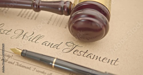 Last will and testament, legacy, inheritance or death tax concept : Fountain pen, a judge gavel on a last will and testament. A form is waiting to be filled and signed by a testator or testatrix.