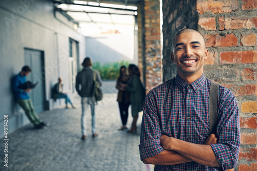 Confident about the college experience. Portrait of a happy young man standing outdoors on campus.