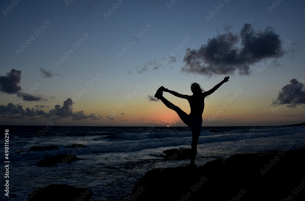 Yoga Toe Hold Balance Pose Silhouetted at Sunrise
