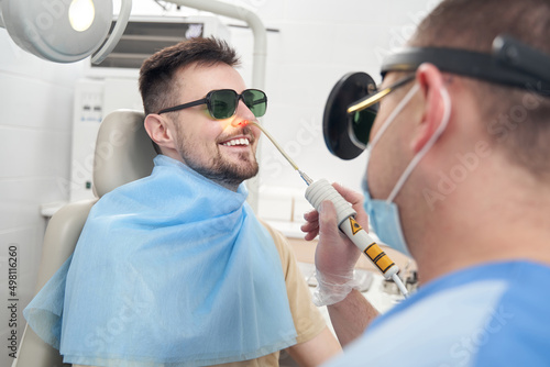 Cheerful male patient during procedures in clinic photo