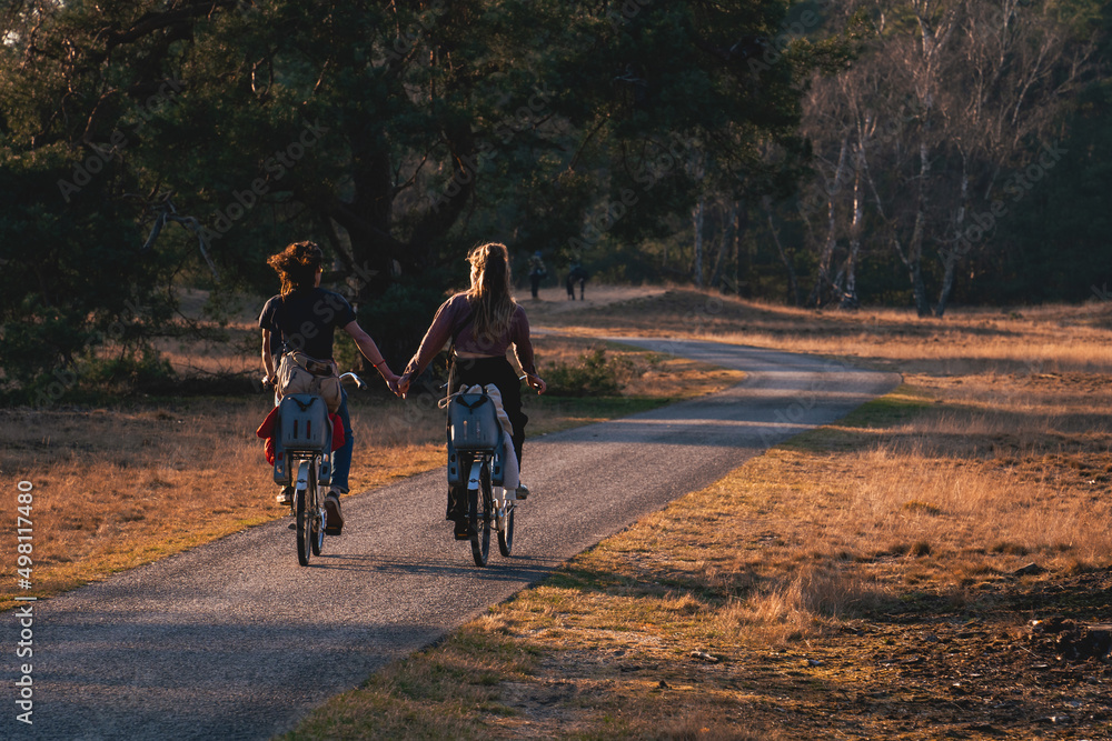 couple riding bikes during sunset