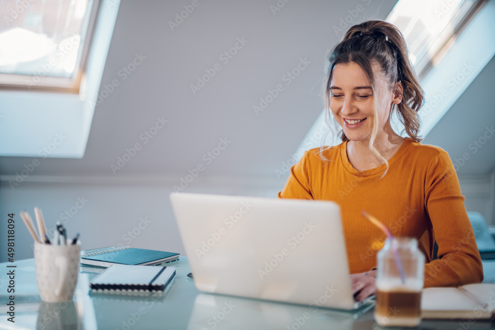 Woman working from a home on her a laptop Woman working from a home on her a laptop
