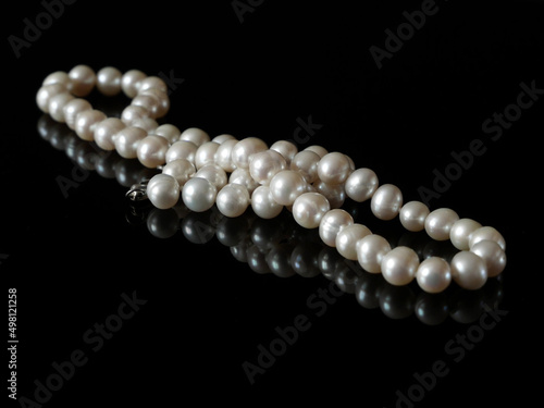 beautiful natural pearls necklace on black background, pawnshop concept, jewerly shop