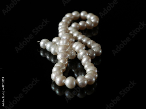beautiful natural pearls necklace on black background, pawnshop concept, jewerly shop