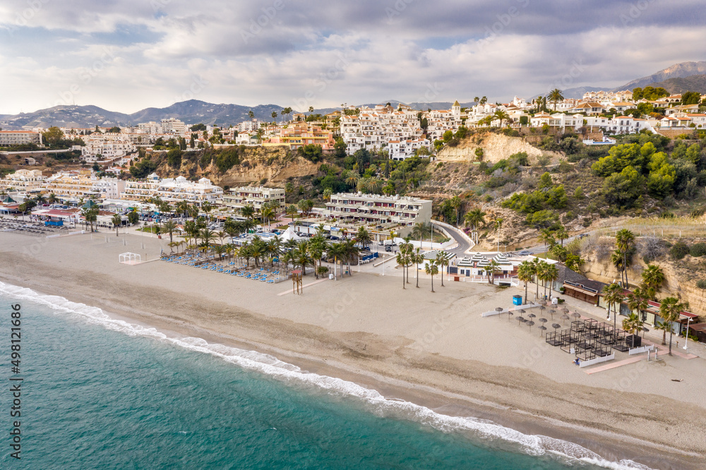 Panoramic aerial view of Burriana beach situated in Nerja Village , Malaga - Spain. Perspective from above of the must big and touristic beach from the city. Cloudy day. Typically Spanish village.