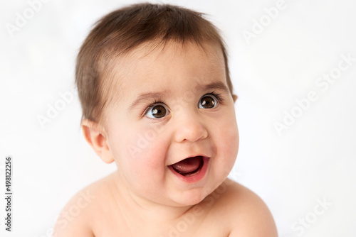 Close-up portrait of smiling baby with open mouth