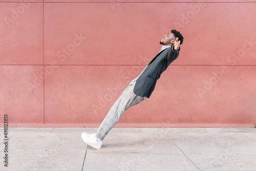 african-american man falling backwards onto concrete floor photo