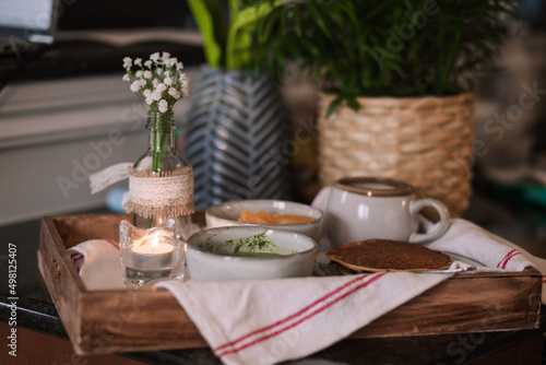 Fototapeta Naklejka Na Ścianę i Meble -  A cozy breakfast setup with green dip, pancake and coffee 