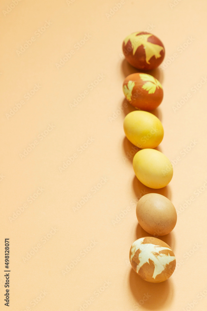 Easter eggs dyed with natural dyes, onion peel, turmeric, beetroot on a light background.