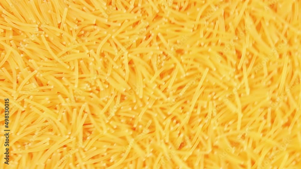Background of Uncooked Noodles Rotating Clockwise - Top View, Angular Rotation. Texture of Dry Vermicelli Turning Around. Raw Pasta - Right Rotation Background of Uncooked Noodles Rotating Clockwise - Top View, Angular Rotation. Texture of Dry Vermicelli Turning Around. Raw Pasta - Right Rotation