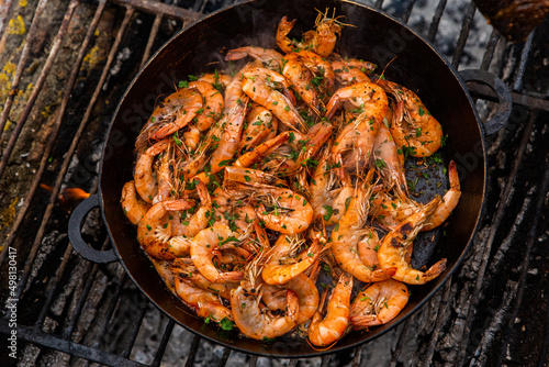 crispy fresh shrimp cooked on a frying pan in the wild. Rest in nature with fresh food 