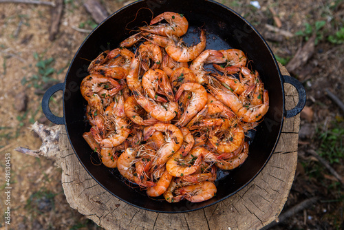 crispy fresh shrimp cooked on a frying pan in the wild. Rest in nature with fresh food 