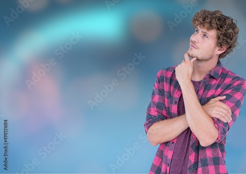 Thoughtful caucasian man with copy space and spots of light on blue gradient background photo