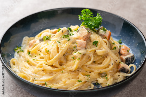 homemade fettuccine pasta with white cream sauce. fettuccine Carbonara made with eggs, hard cheese, cured pork, and black pepper. Italian food.