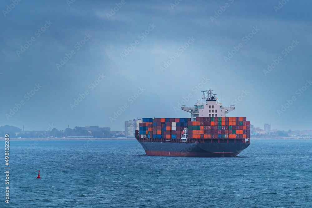 Container ship near the coast, awaiting authorization to enter the port.