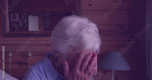Animation of grey texture moving over devastated caucasian senior woman