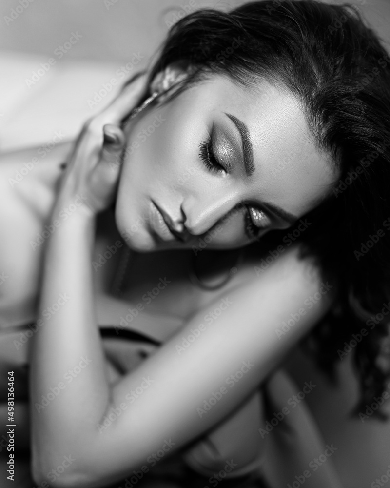 black and white portrait of a beautiful sexy girl with a jacket in his hands pressed to his chest black and white portrait of a beautiful sexy girl with a jacket in his hands pressed to his chest