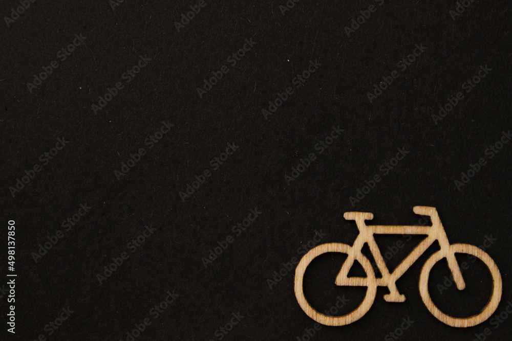 Wooden bicycles, blocks on the black background on the right side Wooden bicycles, blocks on the black background on the right side