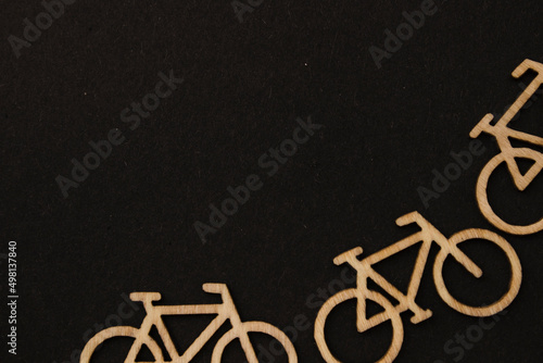 Wooden bicycles, blocks on the black background on the bottom