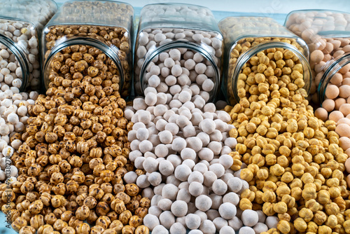 diffierent types of chickpeas in glass jars,white chickpeas,coated chickpeas,sugar coated chickpeas,salty chickpeas photo