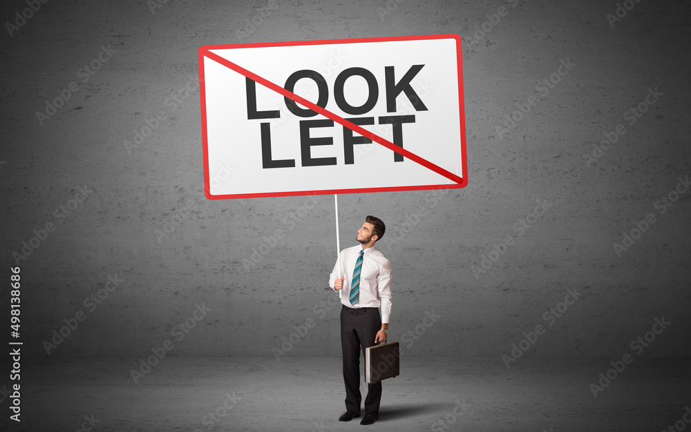 business person holding a traffic sign business person holding a traffic sign