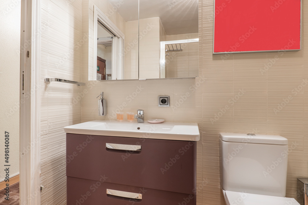 Bathroom with brown wooden cabinet, white resin sink and cabinet with mirror above the sink Bathroom with brown wooden cabinet, white resin sink and cabinet with mirror above the sink
