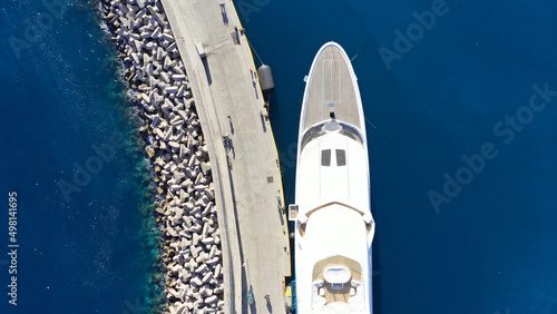 Aerial drone top view photo of luxury yacht anchored in mediterranean port