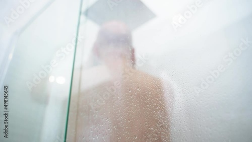 Middle aged man having shower.