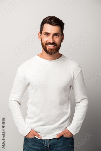 Handsome man in casual style looking at the camera and smiling while posing