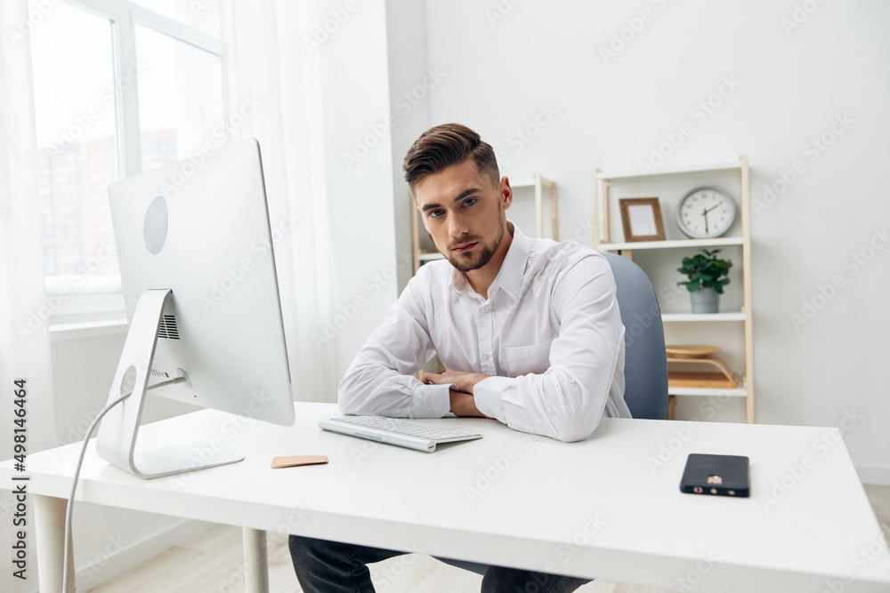 manager sitting at a desk in front of a computer with a keyboard technologies