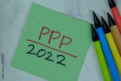 PPP 2022 write on sticky notes isolated on Wooden Table.