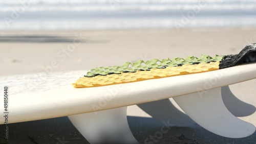 Photography Surfboard for surfing lying on beach sand, California coast, USA