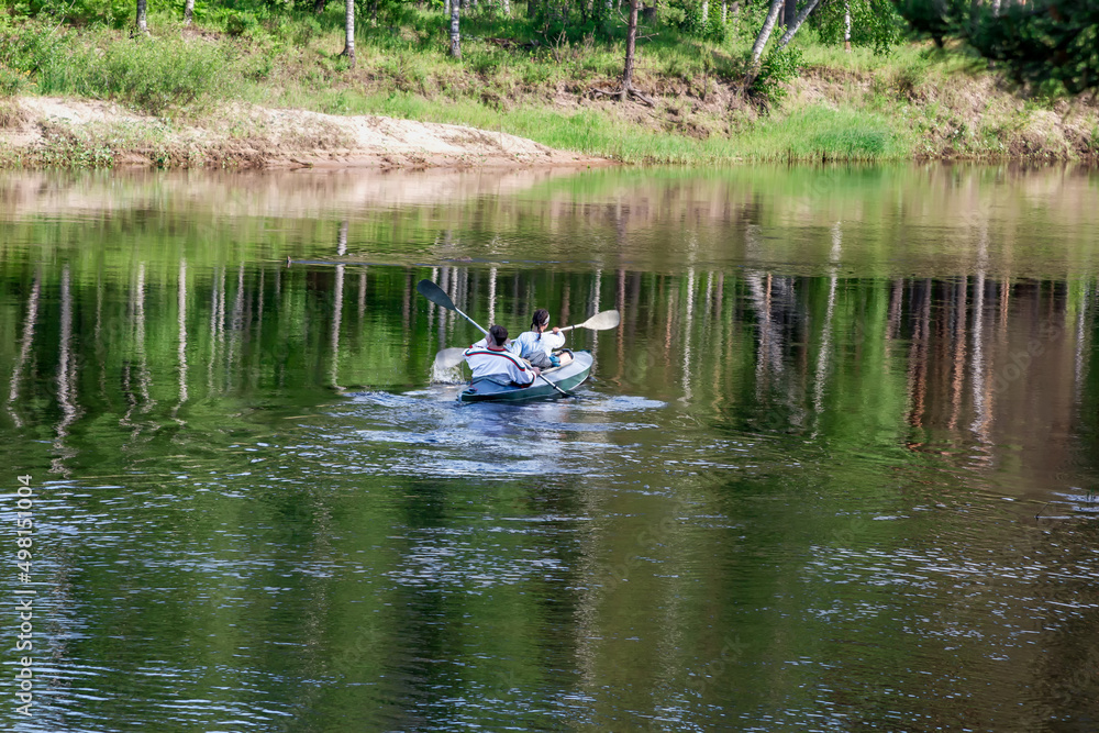 kayak crew sails away into the distance on the river kayak crew sails away into the distance on the river