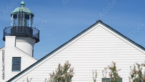 Vintage lighthouse tower, retro light house, old fashioned historic classic white beacon with fresnel lens. Nautical navigational coastal building 1855. Point Loma, Cabrillo, San Diego, California USA