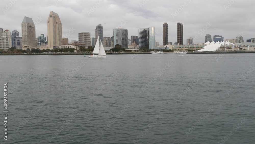 Downtown city skyline, San Diego cityscape, California USA. Waterfront highrise skyscrapers by bay. Urban architecture by harbor. Towers of financial district in Gaslamp Quarter. Overcast weather. Downtown city skyline, San Diego cityscape, California USA. Waterfront highrise skyscrapers by bay. Urban architecture by harbor. Towers of financial district in Gaslamp Quarter. Overcast weather.